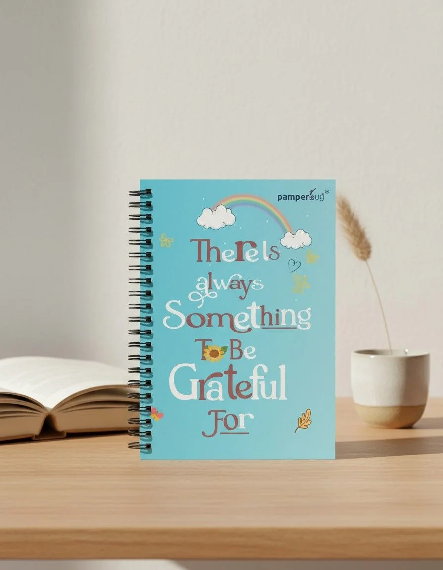 PamperBug daily gratitude journal India teal cover on a wooden desk — KapdeWali