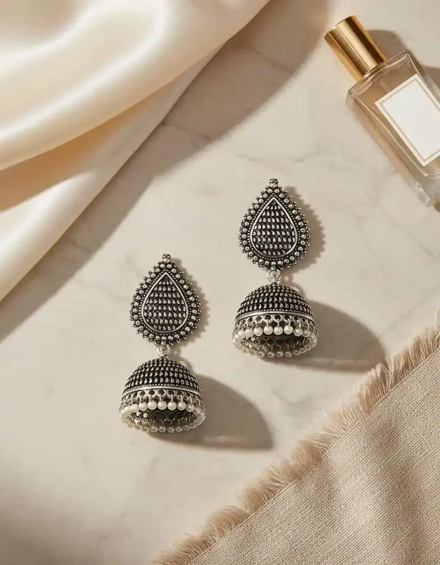 Close-up of TEEJH oxidised jhumkas earrings showing teardrop stud and dome-shaped bell with oxidised jhumkas earrings finish by KapdeWali