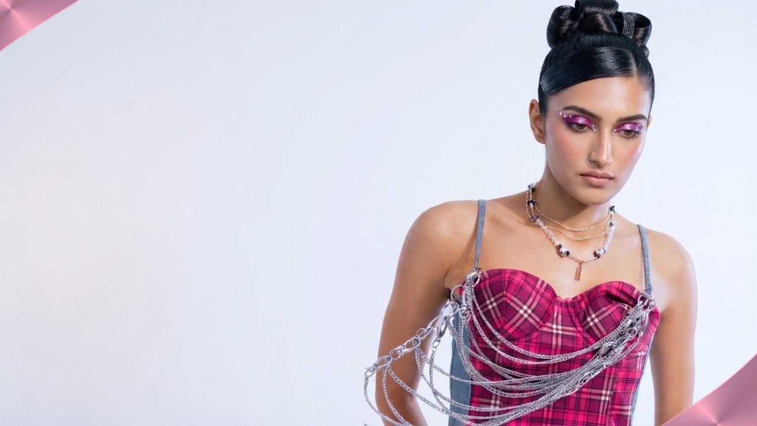 Trishika modeling a pink plaid corset with silver chains