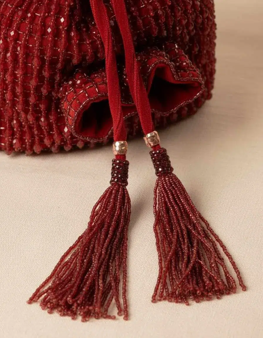Close-up of bead embroidery and velvet drawstring tassels on The Tan Clan velvet potli clutch — velvet potli clutch — The Tan Clan — KapdeWali